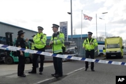 Police officers secure a cordon outside the vehicle recovery business "Ashley Wood Recovery" in Salisbury, England, March 13, 2018.