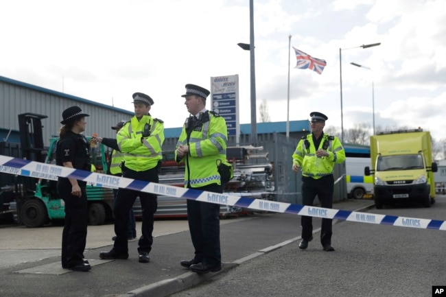 Police officers secure a cordon outside the vehicle recovery business "Ashley Wood Recovery" in Salisbury, England, March 13, 2018.