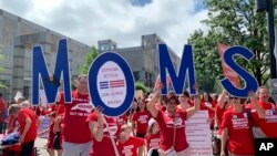 Members of Moms Demand Action march in support of teachers, May 1, 2019, during a teacher rally, in Raleigh, North Carolina.