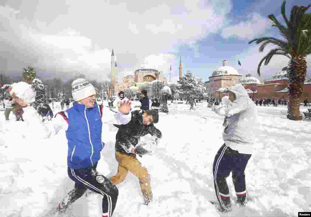 Boys play in the snow at Sultanahmet Square in Istanbul, Turkey.