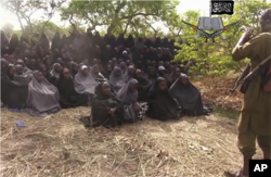 FILE - This file photo taken from video by Nigeria's Boko Haram terrorist network, May 12, 2014, shows the missing girls alleged to be abducted April 14, from the northeastern town of Chibok.