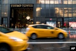 Traffic makes it's way down Fifth Avenue past Trump Tower, Nov. 29, 2016, in New York.