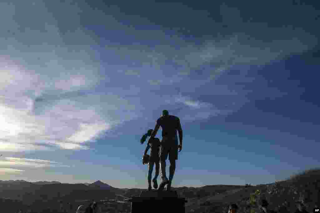 A bronze sculpture honoring former NBA player Kobe Bryant of the&nbsp; Los Angeles Lakers, his daughter Gianna Bryant, and the names of the others who died, is displayed at the site of a 2020 helicopter crash, on a hillside in Calabasas, California, Jan. 26, 2022.