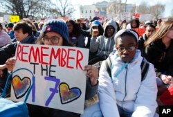 Students sit in silence as they rally in front of the White House in Washington, March 14, 2018.