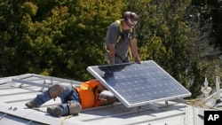 In this Oct. 16, 2015 file photo, a solar panel is installed on the roof of the Old Governor's Mansion State Historic Park in Sacramento, Calif. (AP Photo/Rich Pedroncelli, File)