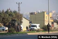 Turkish authorities prepare to detonate an explosive that hit Rehyanli, Turkey on Jan. 31, 2018 and did not immediately explode.