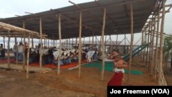 Rohingya men pray under a temporary shelter in the Kutupalong refugee camp in southern Bangladesh, Oct. 2, 2017. 