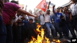 Members of Nepal Student Union affiliated with Nepali Congress chant slogans while they burn an effigy of Prime Minister Baburam Bhattarai in Katmandu, Nepal, May 31, 2012.