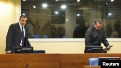 Bosnian Serbs Milan Lukic (L) and Sredoje Lukic (R) sit in the courtroom to attend the appeals verdict in their trial for war crimes in the former Yugoslavia, at the International Criminal Tribunal in The Hague, December 4, 2012.