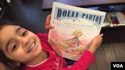 DC resident Jasmine Panchal, four, shows off her latest Books from Birth selection. (J.Taboh, VOA)