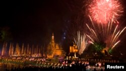 Fireworks light the sky over Wat Mahathat in celebration of the annual Loy Krathong festival in Thailand's Sukhothai Province, Nov. 12, 2008. Northern Thai airports have canceled flights this year due to lantern risks. 