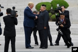 President Donald Trump walks to the North Korean side of the border with North Korean leader Kim Jong Un at the border village of Panmunjom in the Demilitarized Zone, South Korea, Sunday, June 30, 2019. (AP Photo/Susan Walsh)