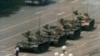 FILE - A Chinese man stands alone to block a line of tanks heading east on Beijing's Cangan Boulevard in Tiananmen Square, June 5, 1989. 