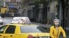 A bicyclist makes his way past a stranded taxi on a flooded New York City Street as Tropical Storm Irene passes through the city, August 28, 2011. A global warming-fueled sea level rise over the next century could flood millions in the US, according to a 