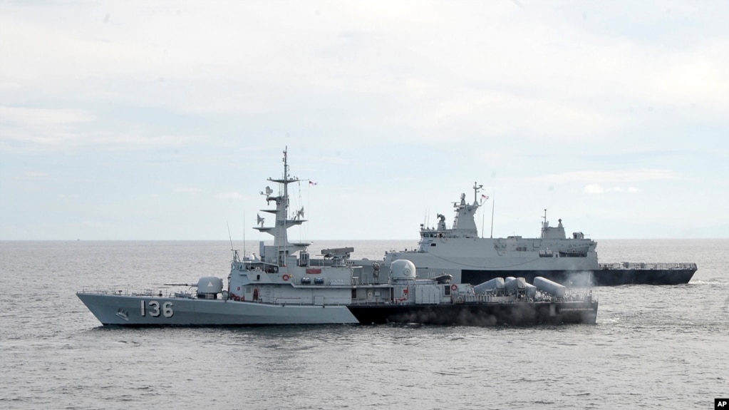 FILE - A Royal Malaysian Navy's missile corvette and an offshore patrol vessel are seen March 13, 2014.