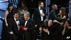 Jimmy Kimmel and Warren Beatty laugh after correcting the Best Picture Oscar from La La Land to Moonlight.