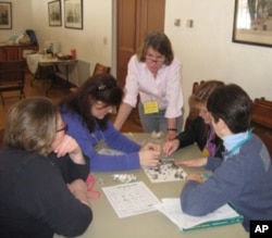 Lisa Purcell training parent volunteers to teach an elementary school workshop on owls.