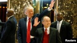 U.S. President-elect Donald Trump and Softbank CEO Masayoshi Son acknowledge guests after meeting at Trump Tower in Manhattan, New York, Dec. 6, 2016.