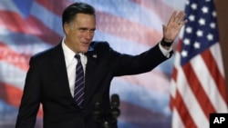 Republican presidential candidate Mitt Romney waves to supporters before conceding at his election night rally, November 7, 2012, in Boston, Massachusetts.