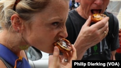 People enjoying a pasteis de Nata, a popular Portuguese pastry made with egg yolks.