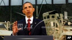 In this May 2, 2012, file photo President Barack Obama talks to soldiers at Bagram Air Field, Afghanistan. In his weekly radio address four days later on Saturday, May 5, Obama said money saved from ending wars in Iraq and Afghanistan should help pay down