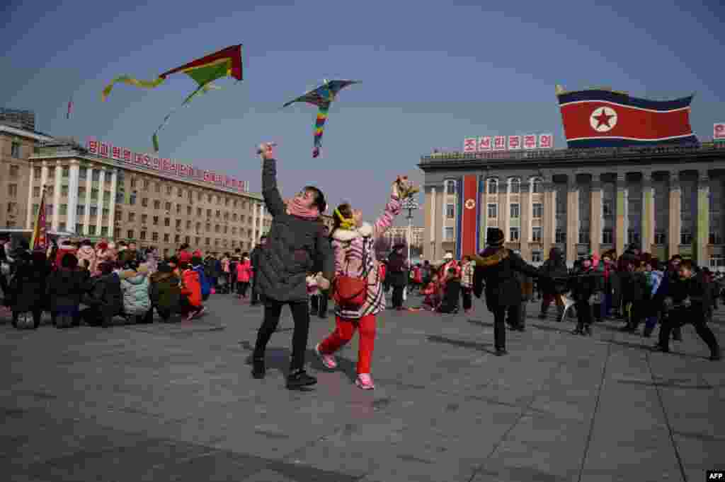 Children fly kites during Lunar New Year festivities on Kim Il Sung square in Pyongyang.