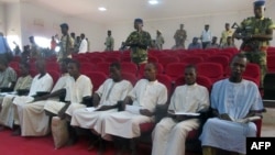 FILE - A picture taken Aug. 26, 2015 shows suspected members of Boko Haram sitting in court in N'Djamena, Chad. 