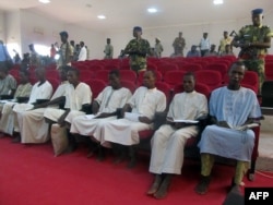 A picture taken Aug. 26, 2015 shows suspected members of Boko Haram sitting in court in N'Djamena.