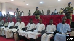 FILE - A picture taken Aug. 26, 2015 shows suspected members of Boko Haram sitting in court in N'Djamena. 