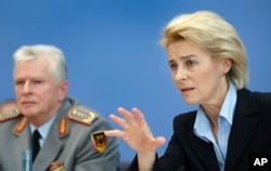 FILE - German Defense Minister Ursula von der Leyen, right, and Volker Wieker, Inspector General of the German armed forces, address the media during a joint press conference in Berlin, Germany, Dec. 3, 2015.