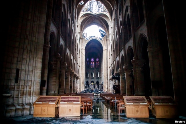 A view of the damaged roof and debris inside Notre-Dame de Paris in the aftermath of a fire that devastated the cathedral during the visit of French Interior Minister Christophe Castaner (not pictured) in Paris, France, April 16, 2019.