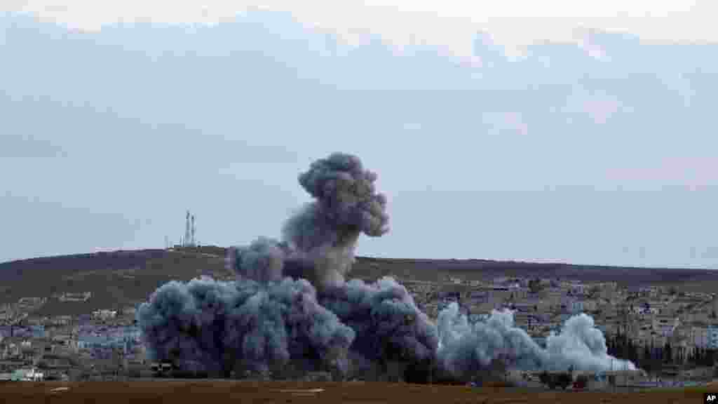 Smoke rises above the Syrian city of Kobani after an airstrike by the U.S.-led coalition, seen from a hilltop on the outskirts of Suruc, near the Turkey-Syria border, Nov. 2, 2014. 