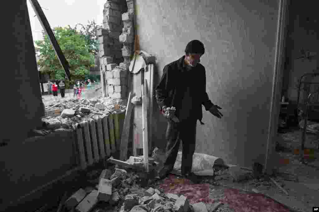 Sorvar Yasinov stands in his destroyed house following a motor attack, outside Slovyansk, eastern Ukraine, May 29, 2014.