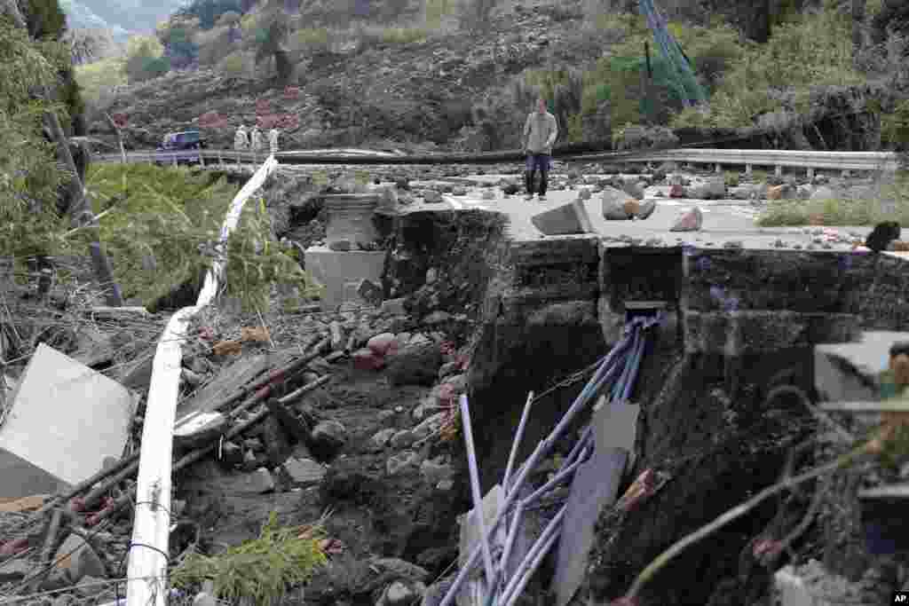 A man walks at a damaged area by earthquakes in Minamiaso, Kumamoto prefecture, April 17, 2016.