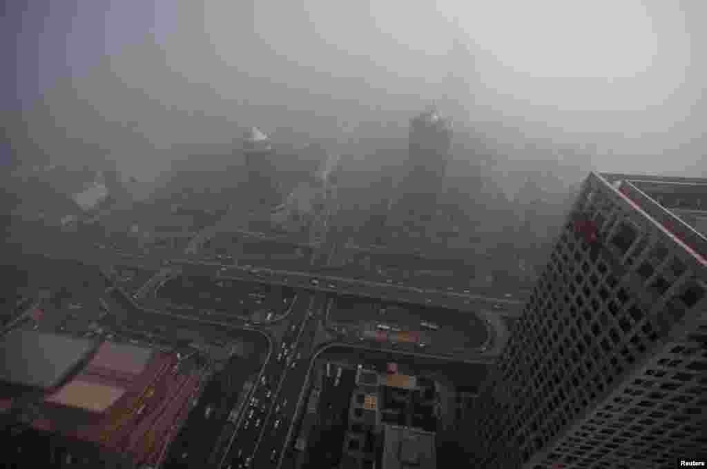 Buildings and the Guomao Bridge are pictured amid heavy haze and smog in Beijing, October 29, 2011. 