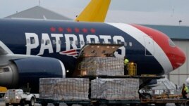 Palettes of N95 respirator masks are off-loaded from the New England Patriots football team's customized Boeing 767 jet on the tarmac, Thursday, April 2, 2020, at Logan Airport in Boston, after returning from China.