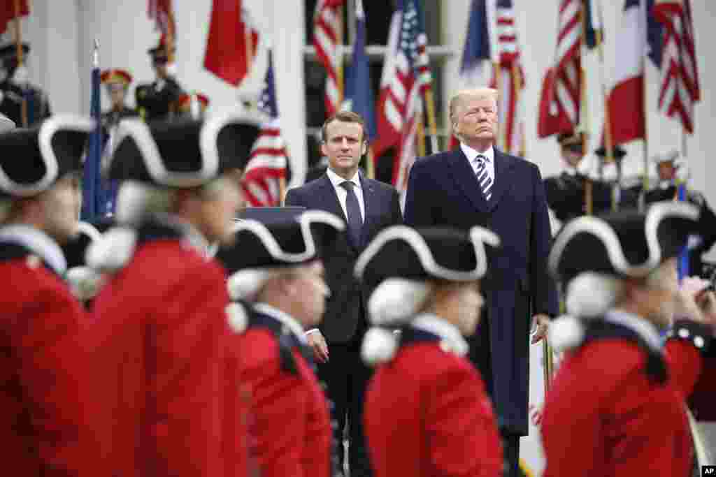President Donald Trump and French President Emmanuel Macron stand during a State Arrival Ceremony on the South Lawn of the White House in Washington, April 24, 2018.