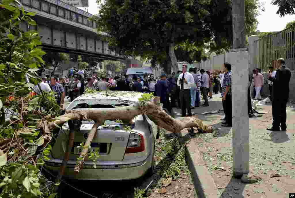 Egyptian security forces inspect the scene after a roadside bomb went off on a busy street in downtown near the foreign ministry in Cairo, Sep. 21, 2014.