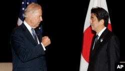 U.S. Vice President Joe Biden (L) gestures tells Japan's Prime Minister Shinzo Abe that Japan is the United States' strongest security partner in the region during their bilateral meeting in Singapore, July 26, 2013.