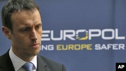 Director of European police cooperation group Europol Rob Wainwright of Britain elaborates on the details of arrests linked to a global child abuse ring during a TV interview after a press conference in The Hague, March 16, 2011