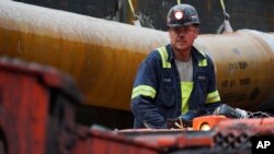 FILE - A miner rworks at a coal mine in Friedens, Pa., June 7, 2017. 