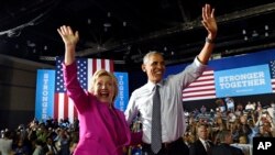 FILE - President Barack Obama and Democratic presidential candidate Hillary Clinton wave following a campaign event at the Charlotte Convention Center in Charlotte, North Carolina, July 5, 2016.