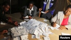 FILE: Zimbabwean election officials count ballot papers after the close of voting on a referendum in Harare, March 16, 2013. Zimbabweans voted on Saturday in the referendum expected to endorse a new constitution that would trim presidential powers and pave the 
