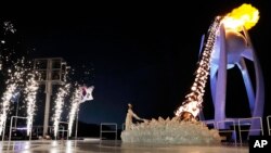 South Korean Olympic figure skating champion Yuna Kim lights the Olympic flame during the opening ceremony of the 2018 Winter Olympics in Pyeongchang, South Korea, Feb. 9, 2018. 