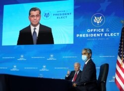 U.S. President-elect Joe Biden and Dr. Vivek Murphy, U.S. President-elect Joe Biden's nominee to be U.S. Surgeon General, listen as Dr. Xavier Becerra, Biden's nominee to be Health and Human Services (HHS) secretary, addresses a news conference via video