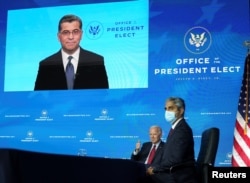 U.S. President-elect Joe Biden and Dr. Vivek Murphy, U.S. President-elect Joe Biden's nominee to be U.S. Surgeon General, listen as Dr. Xavier Becerra, Biden's nominee to be Health and Human Services (HHS) secretary, addresses a news conference via video