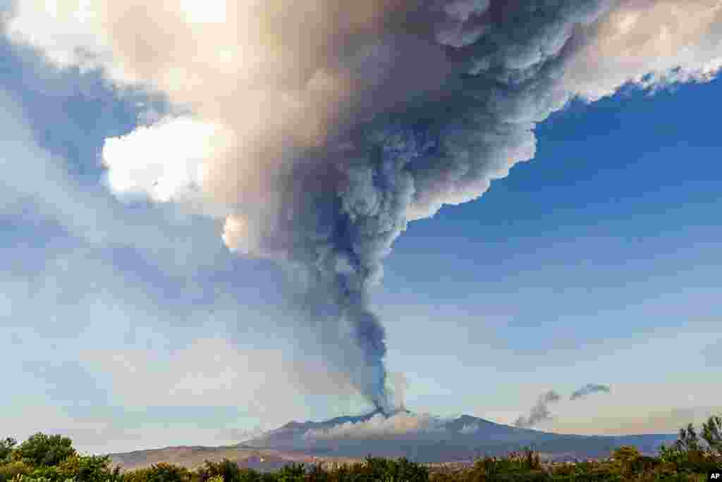 Smoke billows from the Mt. Etna volcano as seen from Giarre, Sicily.