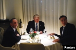 FILE - U.S. President-elect Donald Trump sits at a table for dinner with former Massachusetts Governor Mitt Romney (R) and his choice for White House Chief of Staff Reince Priebus (L) at Jean-Georges at the Trump International Hotel & Tower in New York, Nov. 29