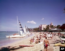 Waikiki beach, Hawaii, in July 1961. Post WWII settlement and tourism led to a boom in housing developments and hotels, leading to more land struggles with Native Hawaiians.