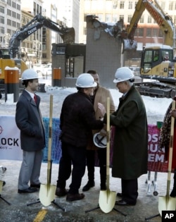 Quicken Loans founder Dan Gilbert, center, meets with Joe Hudson, former CEO of the J.L. Hudson Company at the groundbreaking site of the city's new 800-foot-tall building, Dec. 14, 2017, in Detroit.